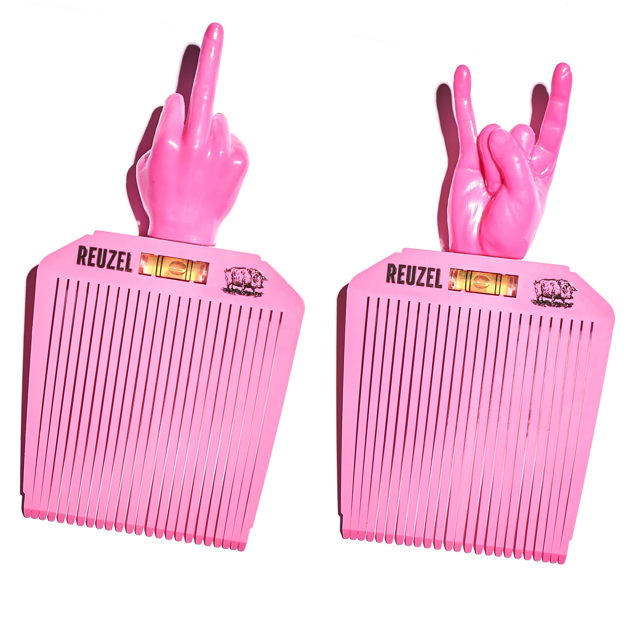 Two pink combs with hand-shaped handles, each displaying a different hand gesture, on a white background. Brand 'REUZEL' is visible.