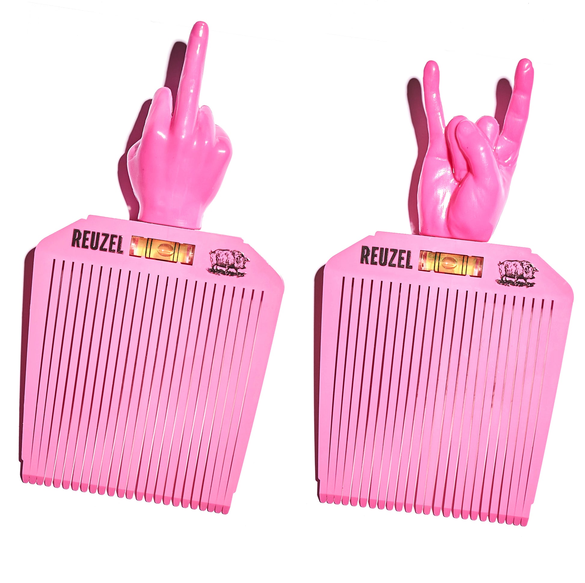 Two pink combs with hand-shaped handles, each displaying a different hand gesture, on a white background. Brand 'REUZEL' is visible.