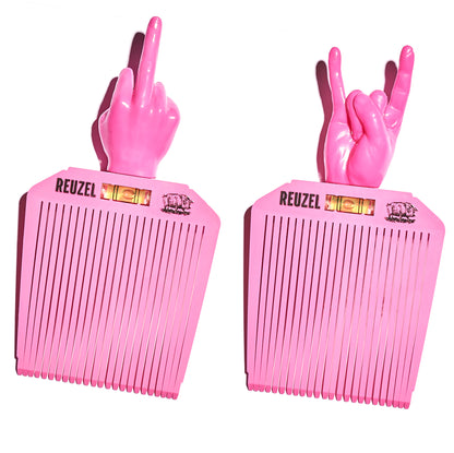 Two pink combs with hand-shaped handles, each displaying a different hand gesture, on a white background. Brand 'REUZEL' is visible.