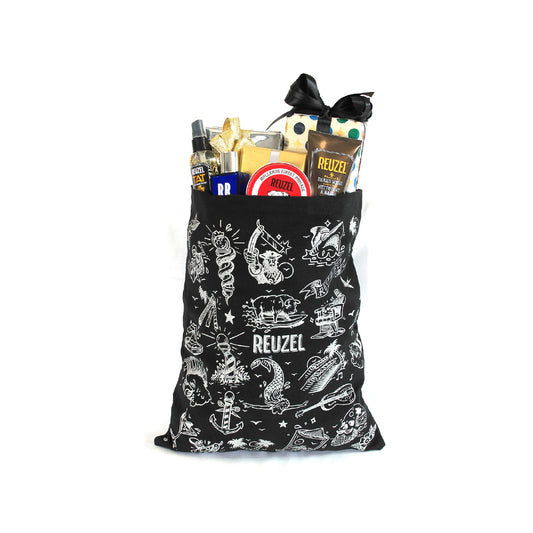 Black tote bag with white graphics filled with Reuzel products on a white background