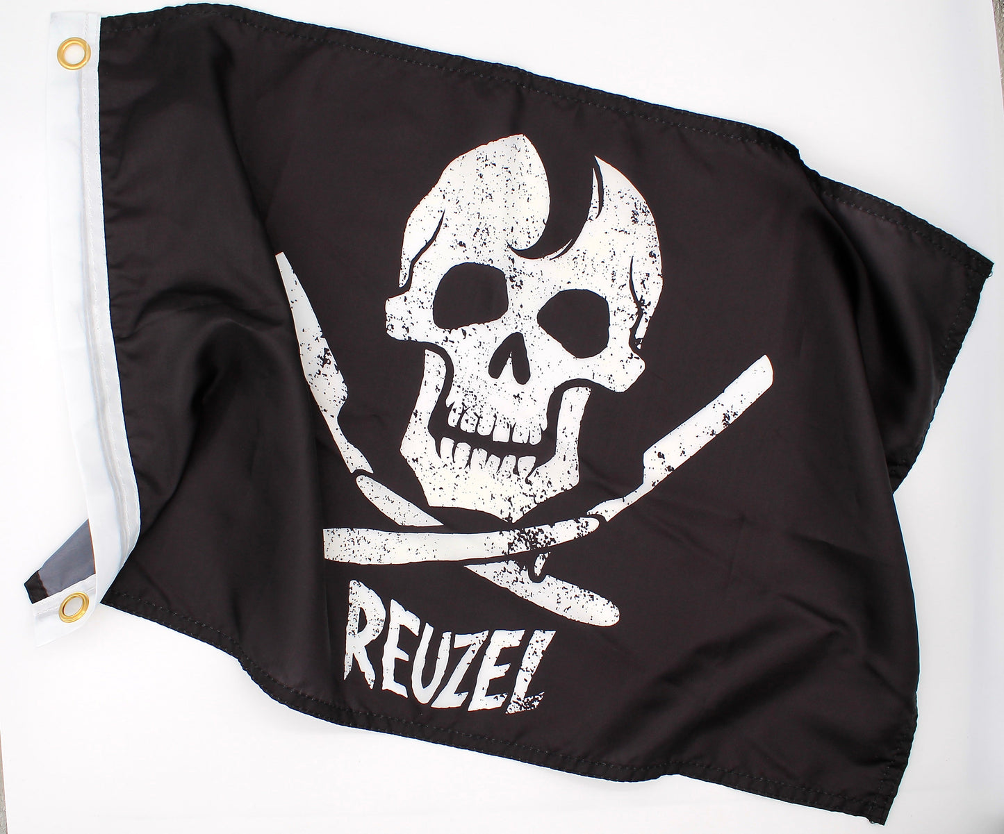 Black pirate flag with a white skull and open razors design and 'REUZEL' branding on a white background.