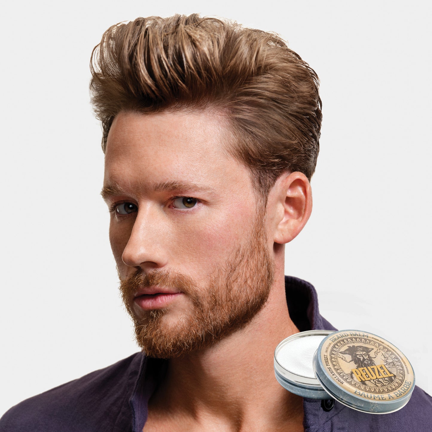 Man with styled hair and Reuzel Beard Balm on a white background