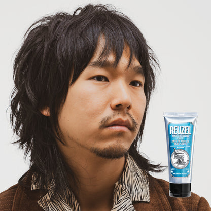 Man with styled hair next to a Reuzel Matte Styling Paste on a white background