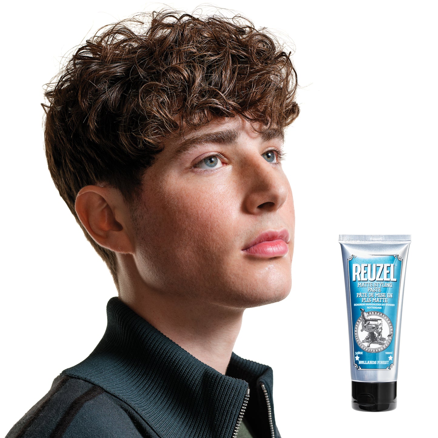 Man with styled hair next to a Reuzel Matte Styling Paste on a white background