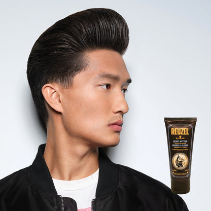 Man with styled hair next to a tube of Reuzel Shave Butter on a light gray background