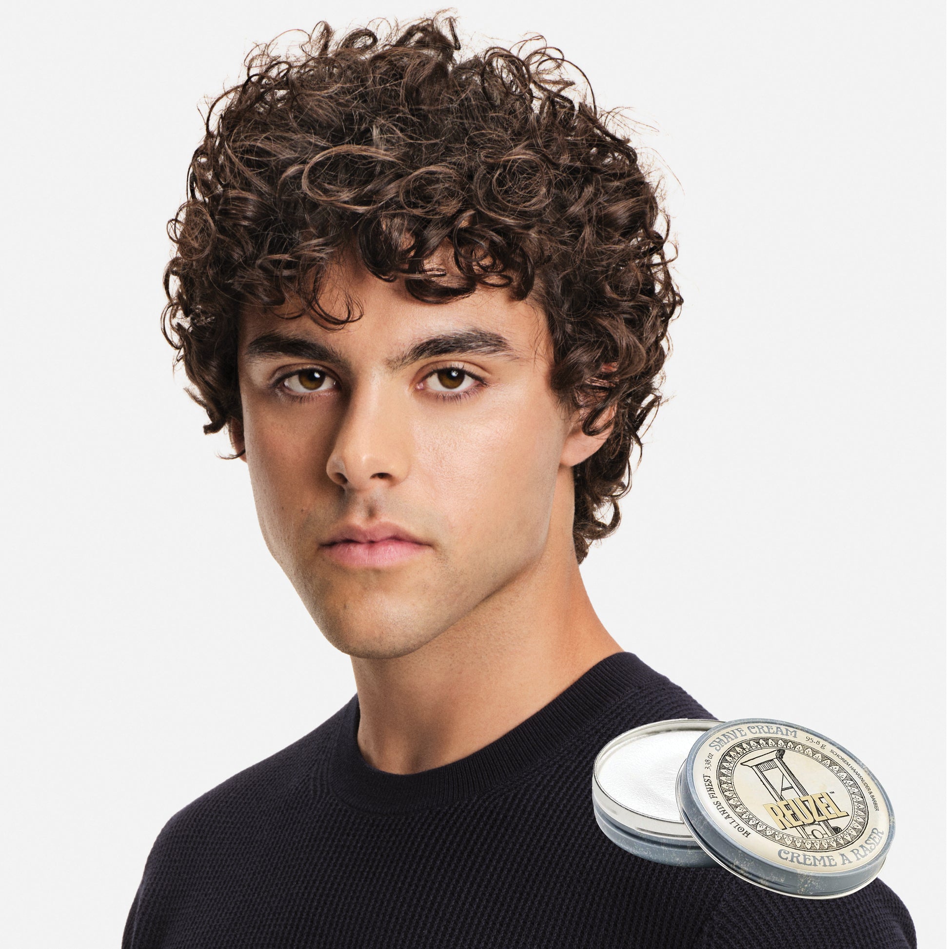 Man with a Reuzel Shave Cream container on a white background